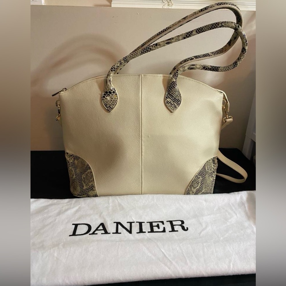 Danier Leather purse with snake skin pattern on handles and corners.